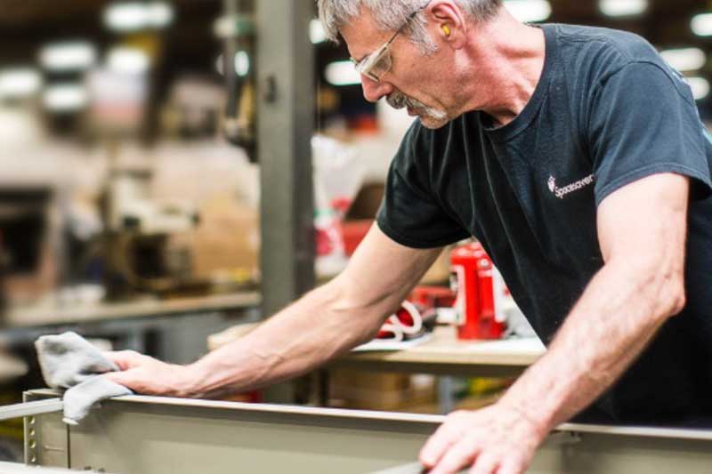 Spacesaver employee working on a metal solution